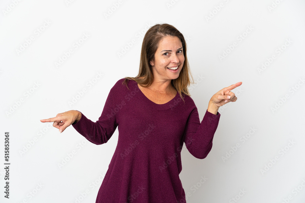 Middle age Brazilian woman isolated on white background pointing finger to the laterals and happy Middle age Brazilian woman isolated on white background pointing finger to the laterals and happy