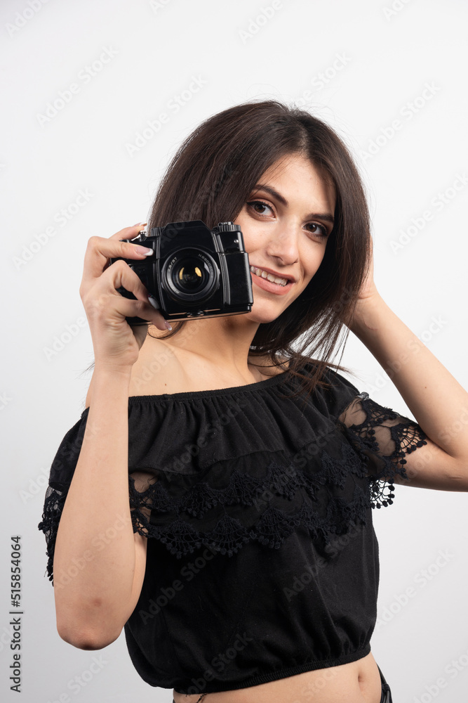 Brunette woman taking pictures with camera Brunette woman taking pictures with camera