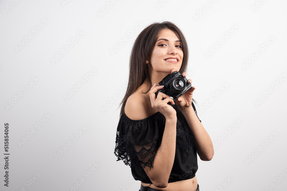Brunette woman preparing to take pictures on white background Brunette woman preparing to take pictures on white background