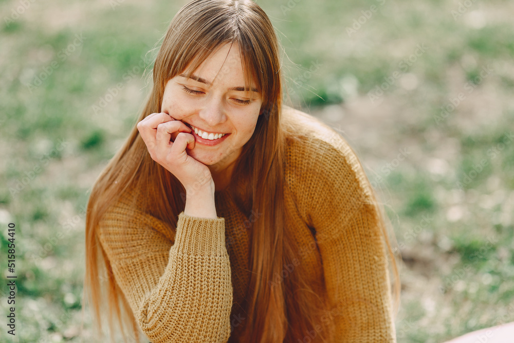 Elegant woman in a brown sweater in a spring park Elegant woman in a brown sweater in a spring park