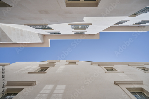Low angle view of buildings architecture geometry and blue sky for text space