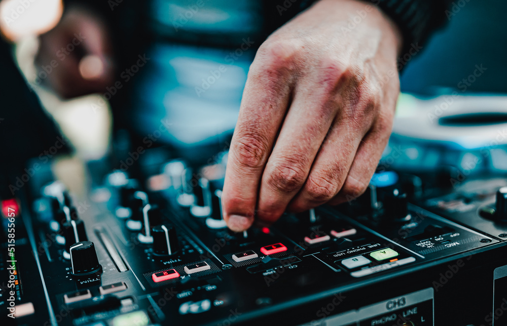 DJ Hands creating and regulating music on dj console mixer in concert outdoor DJ Hands creating and regulating music on dj console mixer in concert outdoor