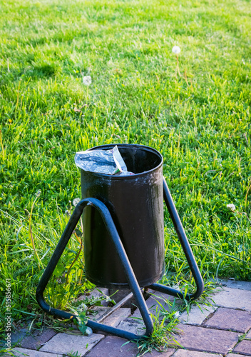 metal trash bin in parkland photo