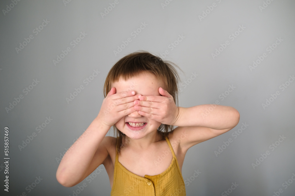 Cute child closes his eyes with his hands Cute child closes his eyes with his hands