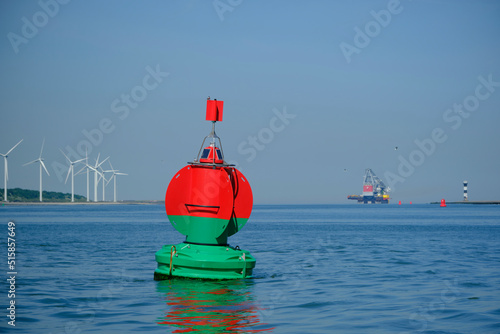 Green red buoy to mark a split in the canal Nieuwe Waterweg in the harbor of Rotterdam. photo