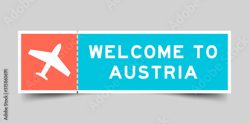 Orange and blue color ticket with plane icon and word welcome to austria on gray background