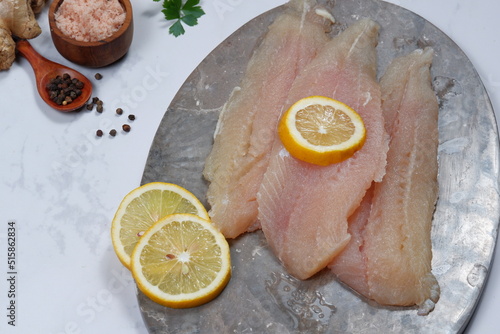 Fresh Pangasius dory Fish Fillet with ingredient on white background photo