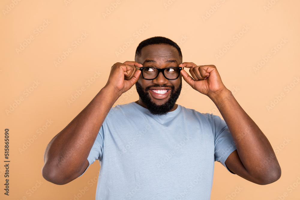 Photo of impressed young brunet guy look promo wear eyewear blue outfit isolated on beige color background Photo of impressed young brunet guy look promo wear eyewear blue outfit isolated on beige color background