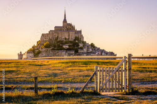 The Mont Saint-Michel tidal island at sunset in Normandy, France.