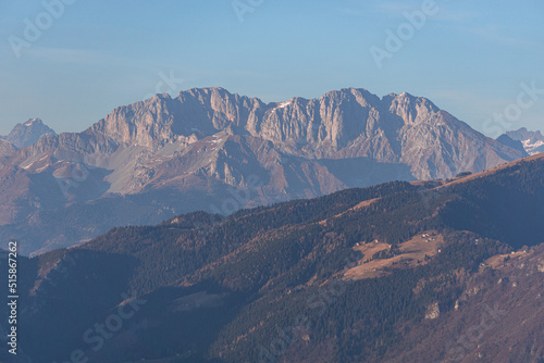 Fototapeta Naklejka Na Ścianę i Meble -  The mountains between val camonica and val seriana, near lake iseo, during the golden hour of a winter day, near the town of Zone, Italy - February 2022.