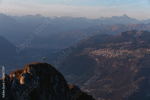The mountains between val camonica and val seriana, near lake iseo, during the golden hour of a winter day, near the town of Zone, Italy - February 2022. photo