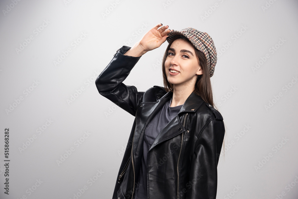 Young woman wearing black leather jacket and cap Young woman wearing black leather jacket and cap