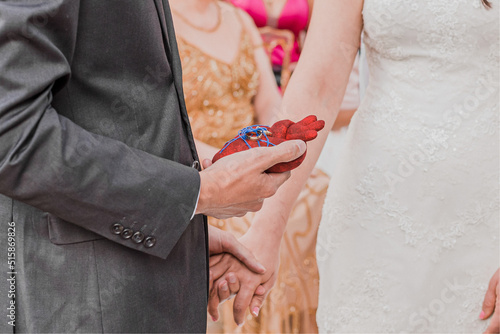 hands of bride and groom at Happy wedding ceremony whit real heart to exchange of wedding rings photo