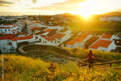 Quadro em tela Girl watching the sunset over Ponta Delgada, Sao Miguel, Azores, Portugal