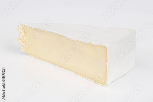Soft brie cheese on a white background, a piece of dairy delicacy.