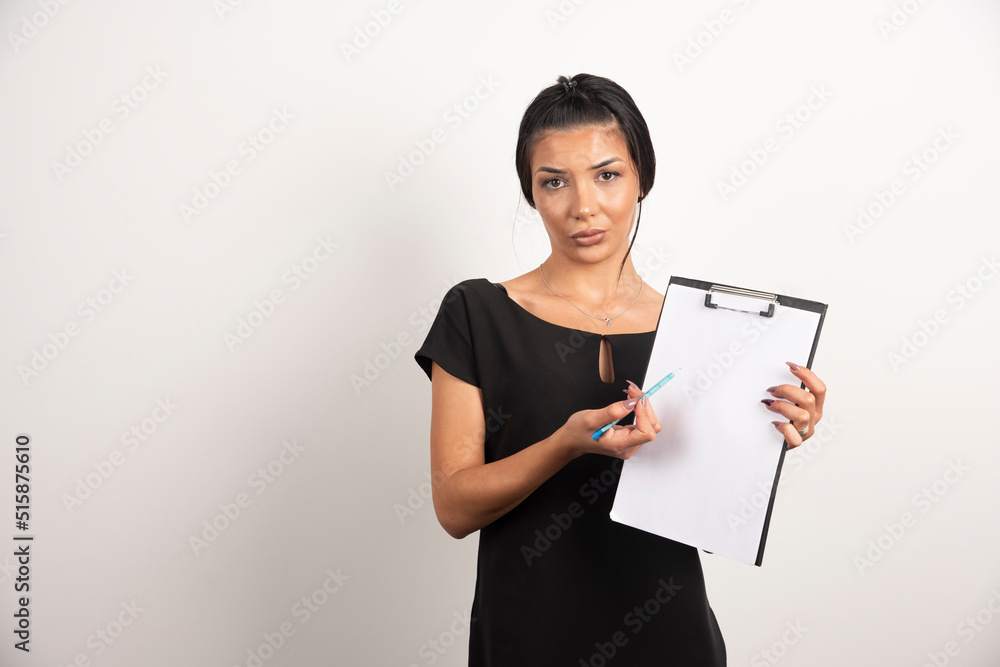 Young businesswoman pointing at important note Young businesswoman pointing at important note