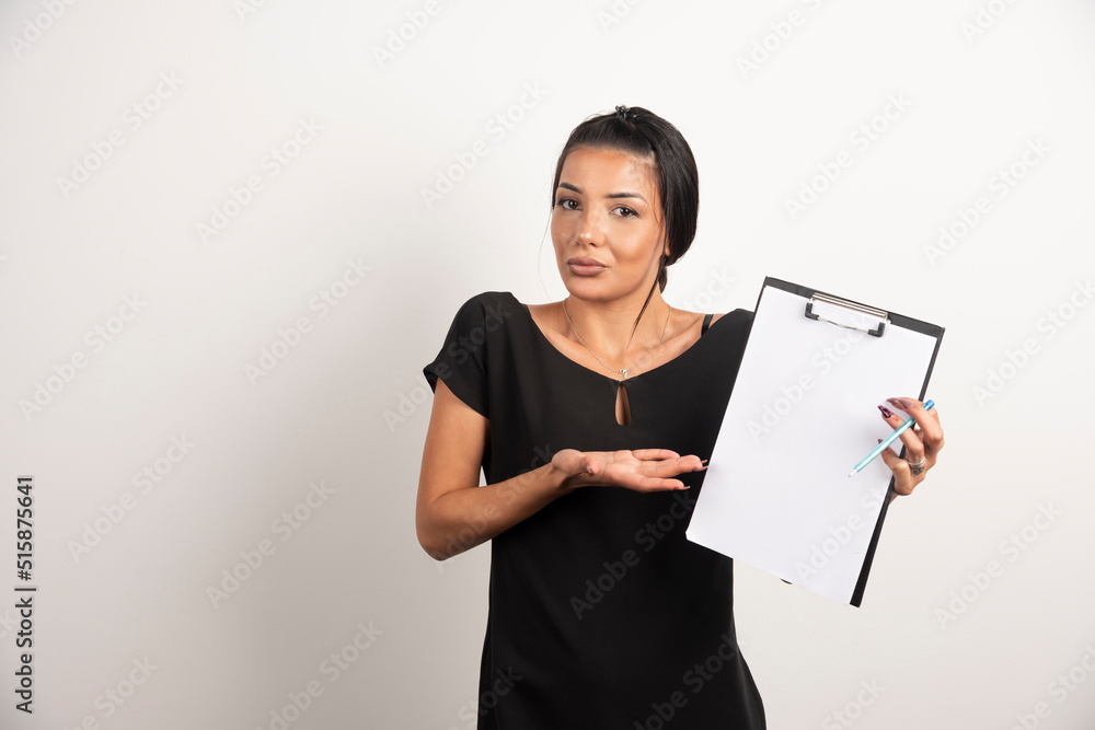 Young businesswoman showing clipboard on white background Young businesswoman showing clipboard on white background