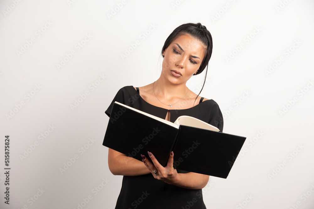 Businesswoman reading notes on white background Businesswoman reading notes on white background