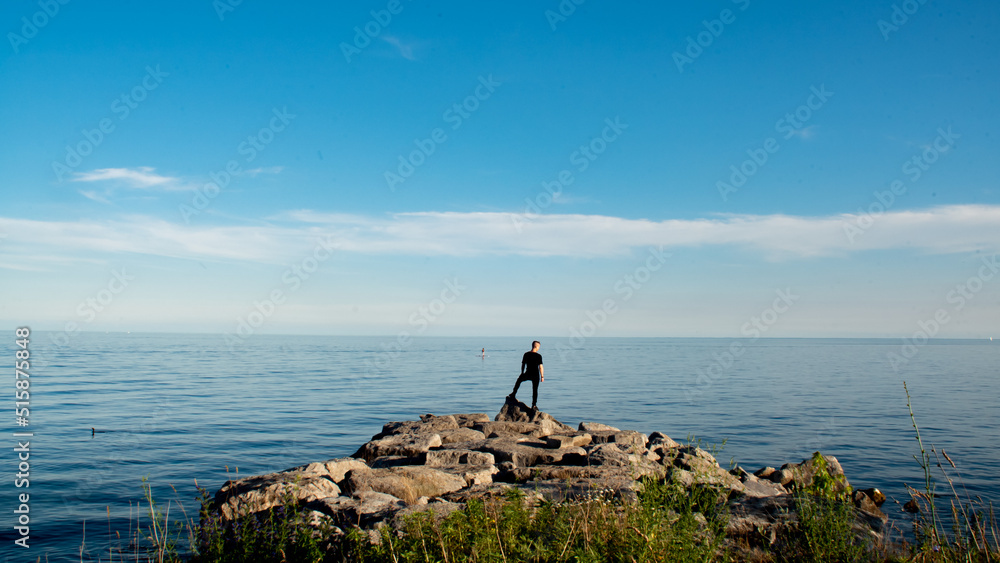 Man looking at Lake Ontario before sunset Man looking at Lake Ontario before sunset