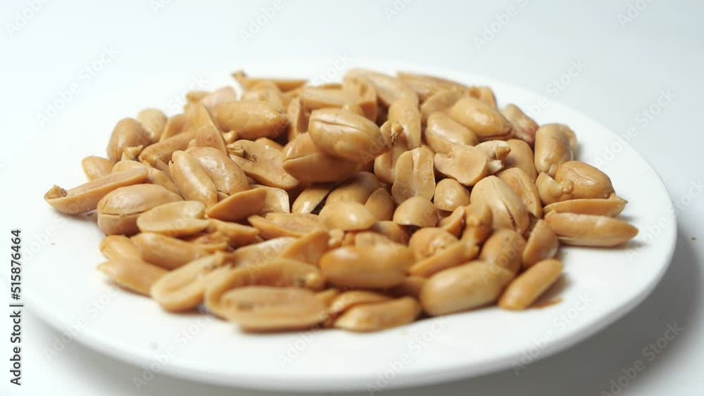slow motion of pouring Processed pea nuts in a plate slow motion of pouring Processed pea nuts in a plate