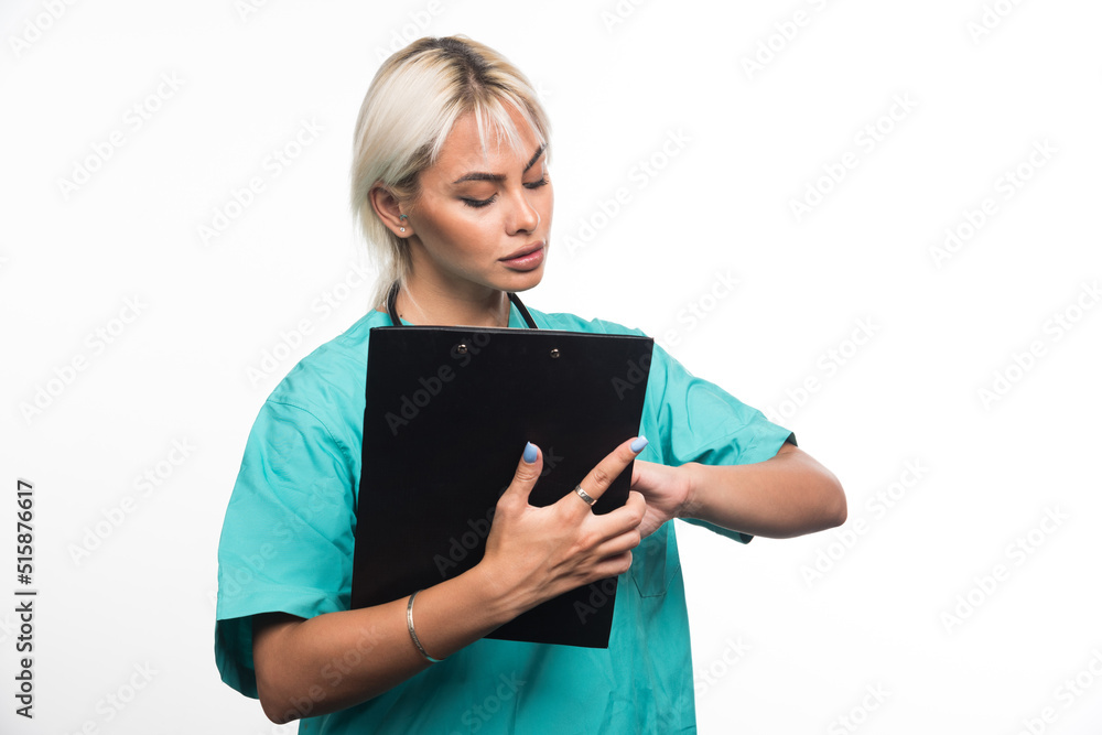 Female doctor checking clipboard on white background Female doctor checking clipboard on white background