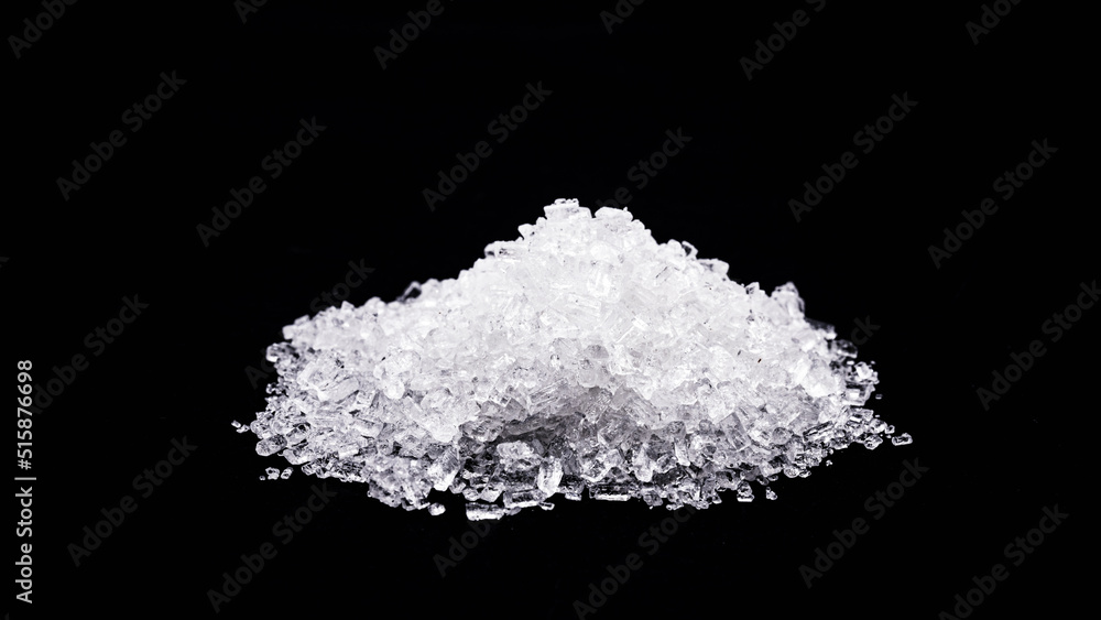 sodium chloride, known as salt or table salt, an important food preservative and a popular seasoning, isolated on black background
