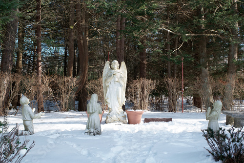 Sculptures of Angel and praying Fatima children in Our lady of Fatima shrine Holliston MA USA photo