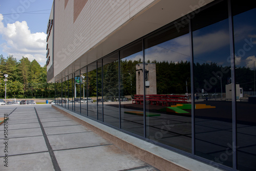 Shopping center with glazed first floor, tinted glazing black