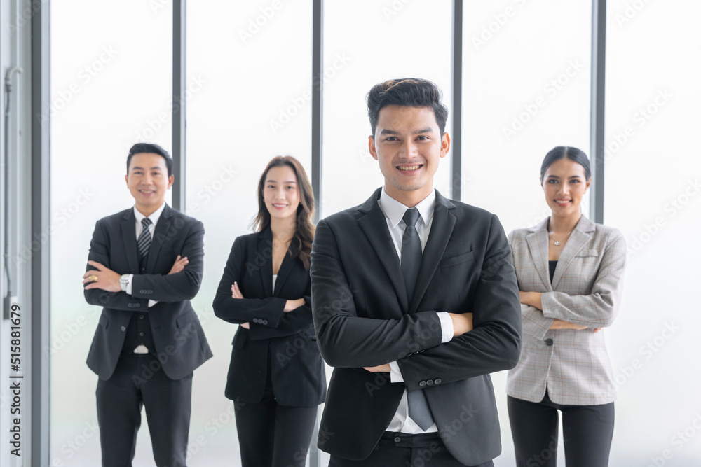 Asian businessman looking at the camera Working and meeting at the office at the company with colleagues at the back Asian businessman looking at the camera Working and meeting at the office at the company with colleagues at the back