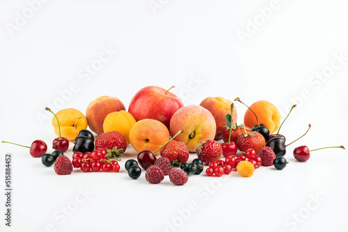 On a white background different ripe fruits and berries.
