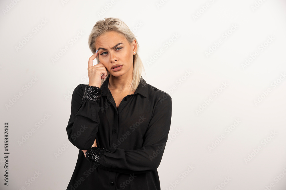 Portrait of thoughtful woman in black shirt posing on white background Portrait of thoughtful woman in black shirt posing on white background