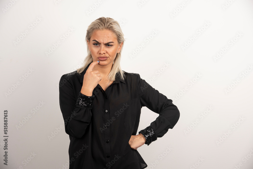 Portrait of beautiful woman in black shirt posing on white background Portrait of beautiful woman in black shirt posing on white background