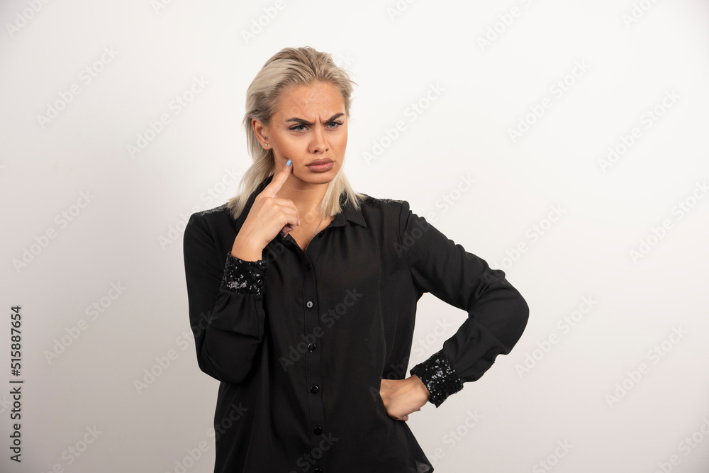 Portrait of woman in black shirt posing on white background Portrait of woman in black shirt posing on white background
