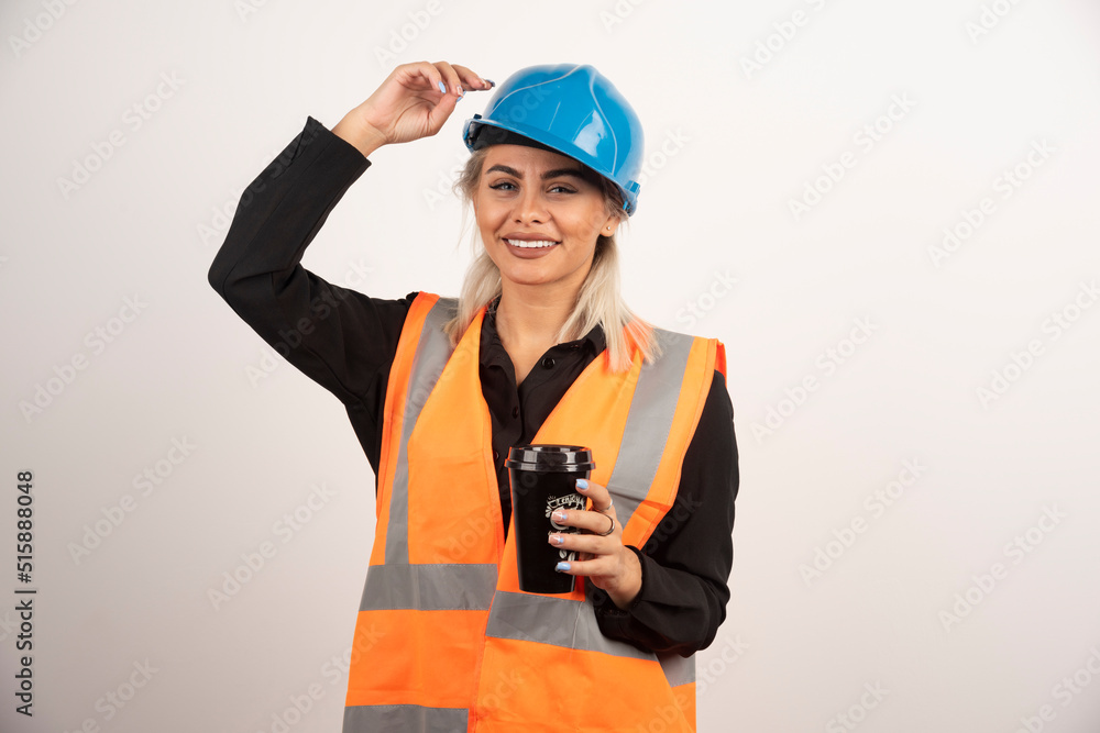 Construction worker with cup of tea feeling happy Construction worker with cup of tea feeling happy