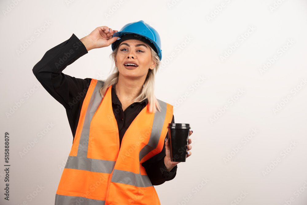 Construction worker posing with cup of tea on white background Construction worker posing with cup of tea on white background