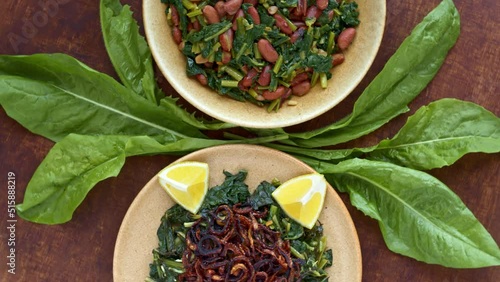 Two famous Mediterranean dish with chicory leaves. Lebanon Hindbeh Bi Zeit (chicory with olive oil) and Italian Cicoria e Fagioli (Chicory and beans). Borlotti beans aka cranberry beans aka rosecoco. photo