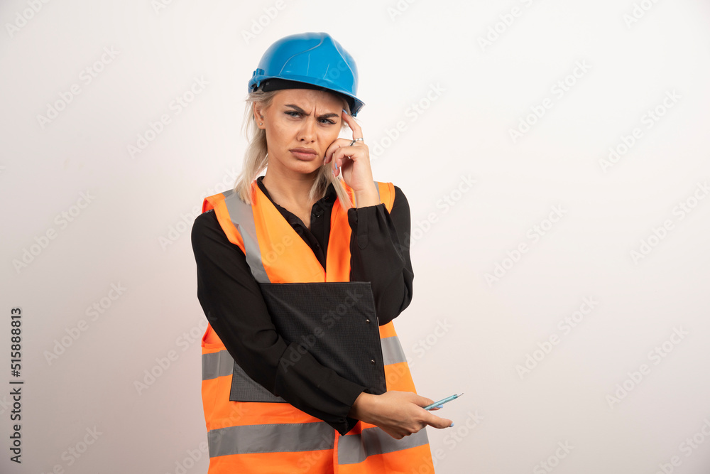 Woman industrial worker holding clipboard on white background Woman industrial worker holding clipboard on white background