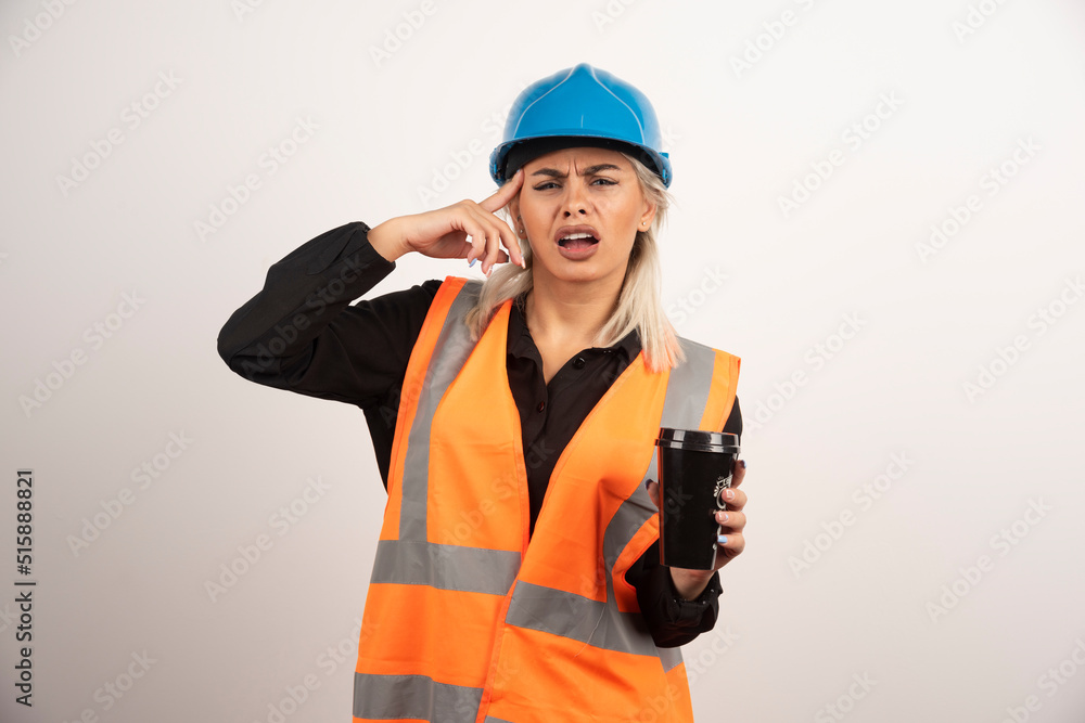 Woman worker with cup of tea having headache Woman worker with cup of tea having headache