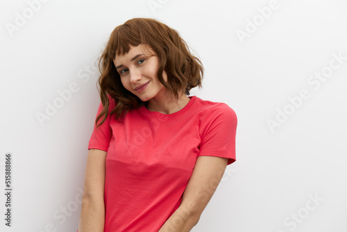 horizontal photo of a sweet, shy, pleasant woman standing on a white background with an empty space for inserting an advertising layout