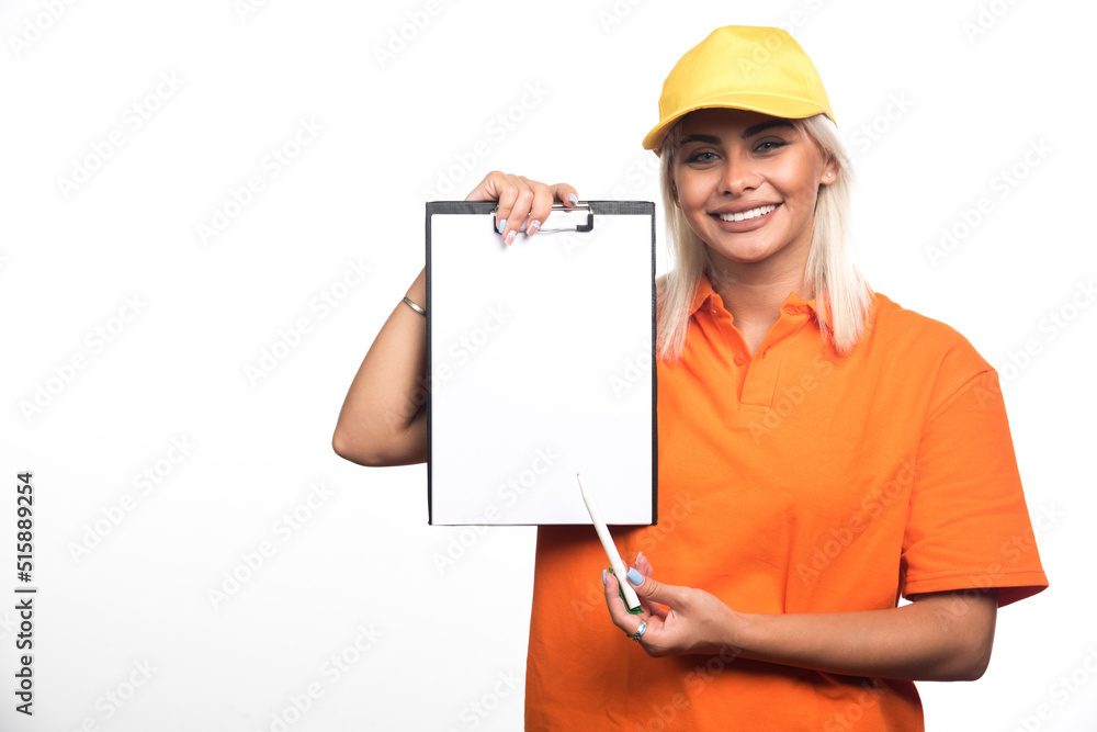 Female courier pointing at empty notebook on white background Female courier pointing at empty notebook on white background