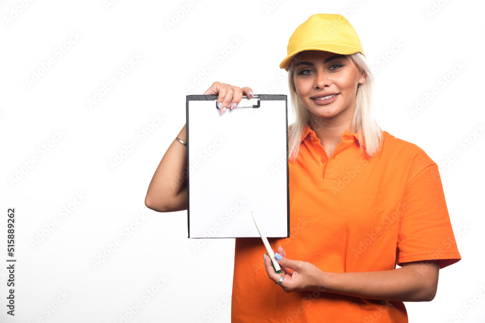 Female courier pointing at empty notebook on white background Female courier pointing at empty notebook on white background