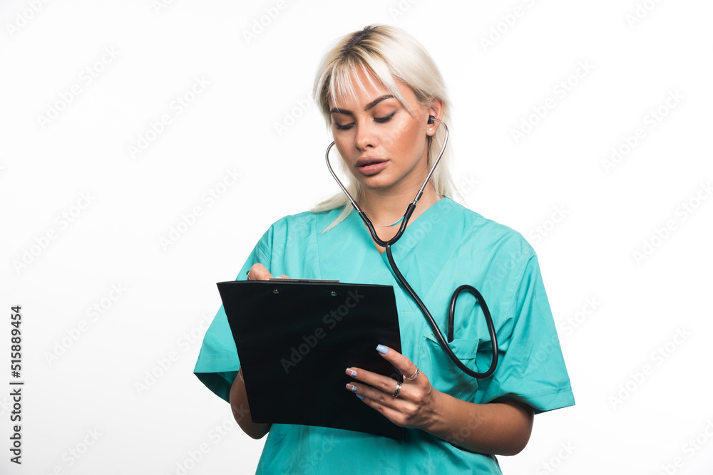 Female doctor writing something on clipboard on white background Female doctor writing something on clipboard on white background