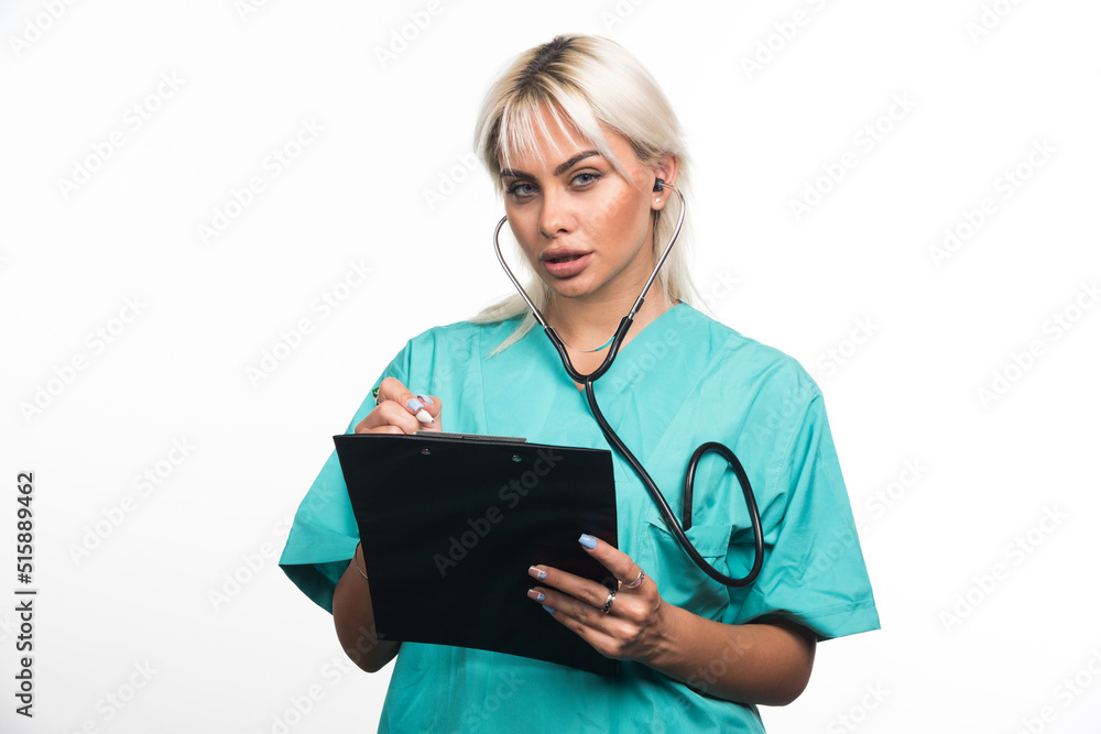 Female doctor writing something on clipboard on white background Female doctor writing something on clipboard on white background