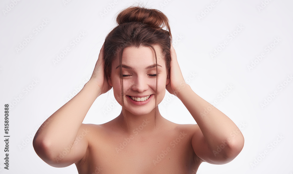 Healthy skin woman portrait with nude makeup hair tied in knot. Spa and health care. Isolated on white Healthy skin woman portrait with nude makeup hair tied in knot. Spa and health care. Isolated on white