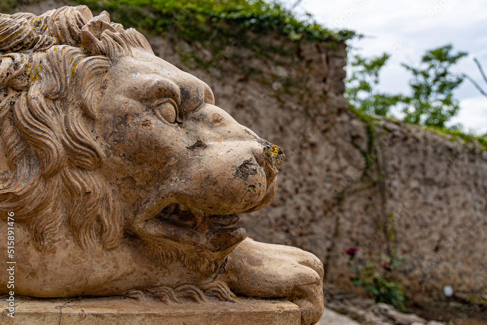 old lion statue in the park 