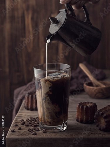 Ice coffee with cream and canele photo