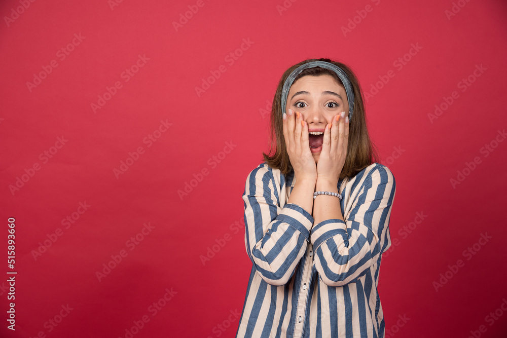 Beautiful girl covering mouth with both of hands and screaming Beautiful girl covering mouth with both of hands and screaming