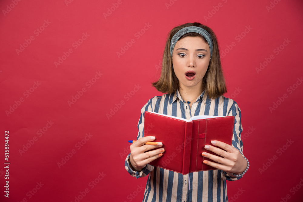 Young girl getting shocked about story of book Young girl getting shocked about story of book