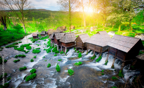 Old small wooden water mills called Mlincici by the Pliva lakes near the Jajce town in Bosnia and Herzegovina photo