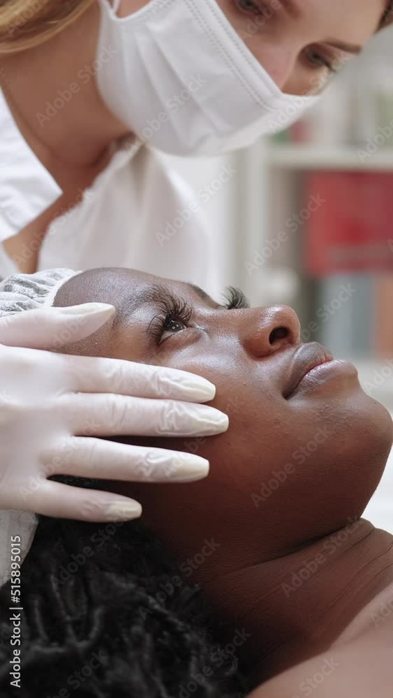 Vertical video. Beauty salon. Female patient. Skin care checkup
